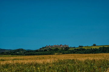 Beautiful view of the small medieval village with stone walls of Monteriggioni in province of Siena, Tuscany Italy.