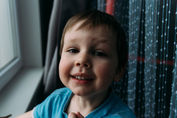 naughty boy smiling at camera, portrait of a child