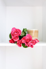 Beautiful pink roses bouquet and the transparent glass cup of hot latte on white background