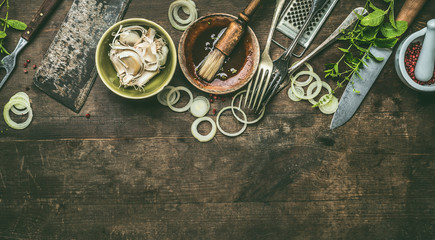 Kitchen utensils on rustic wooden background with fresh seasoning, BBQ simple marinade, top view....