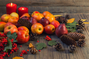 Autumn food background with apples, pine cones, spices, berries and fallen leaves with copy space for text. Autumn food backdrop. Selective focus.