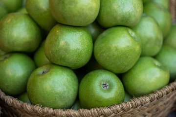 Fresh produce on sale at the local farmers market. Ripe organic apples in a basket. Freshly,...