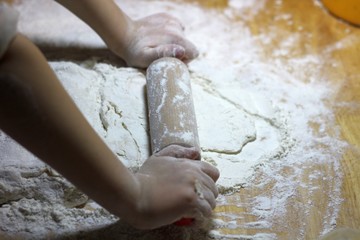 Children's hands and dough. Little boy kneading a dough. Healthy handmade food concept. bakery...