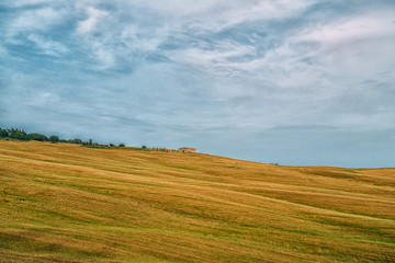 Fototapeta premium Beautiful landscape with farmhouse, one of the most famous places in Tuscany, Italy. Tourism, travel in Italy. Beautiful destination Europe. Summer holiday outdoor vacation trip.