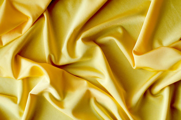 Background from satin fabric of yellow color.