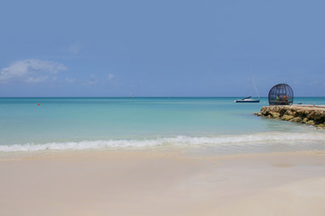 Sand Beach of Antigua, dream beach with a little sailboat on the horizon, Caribbean Sea