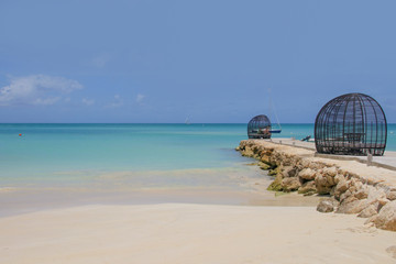 Fototapeta premium Sand Beach of Antigua, dream beach with a little sailboat on the horizon, Caribbean Sea