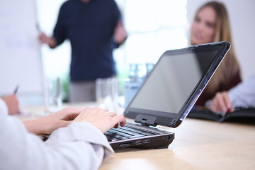 Frauenhände schreiben auf einem Laptop während eines Vortrages