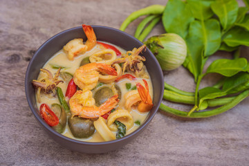 Thai food chicken green curry on dark wooden background. top view