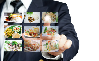Businessman hand making selection of food menu with digital touch screen