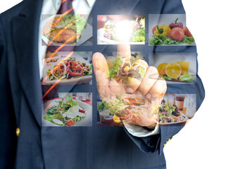 Businessman hand making selection of food menu with digital touch screen