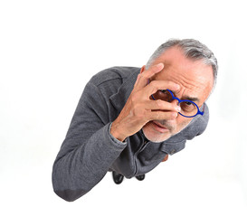man peeking with hand on face on white background