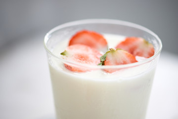 Fresh strawberry on a glass with dessert yogurt and strawberry  on white background