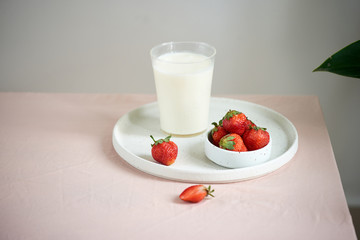 strawberry and yogurt on pink background