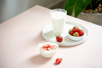 strawberry and yogurt on pink background