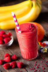 Tasty smoothie with essential nutrients and two straws