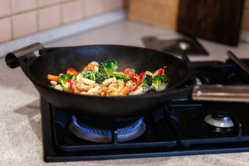 turkey meat stew with fresh vegetables cooked in a wok pan