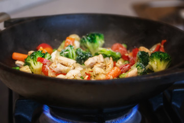 turkey meat stew with fresh vegetables cooked in a wok pan
