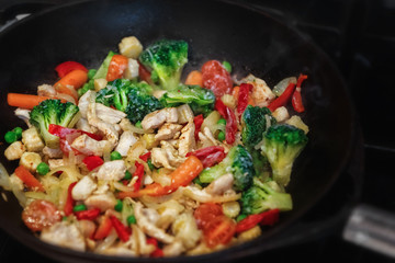 turkey meat stew with fresh vegetables cooked in a wok pan