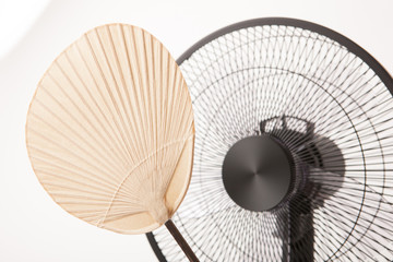 electric fan with asian bamboo fan isolated white