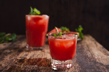 Refreshing summer watermelon juice in glasses with slices of watermelon