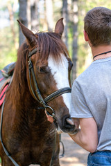 Obraz premium guy with a horse in nature
