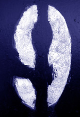 Number 9 in stencil on metal wall in blue tone.