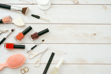 Manicure set and nail polish on wooden background