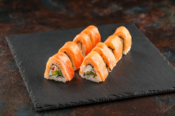 Japanese sushi on a rustic dark background.