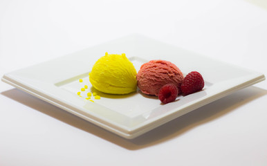 Set of ice cream scoops of different colors and flavours with fruits decoration isolated on white background 