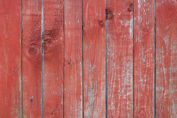 old wooden scratched background with vertical lines and knots with old red paint