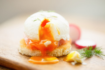 Poached egg sandwich with salmon, dill, radish, selective focus