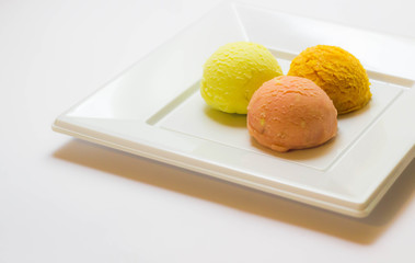 Set of ice cream scoops of different colors and flavours with fruits decoration isolated on white background 