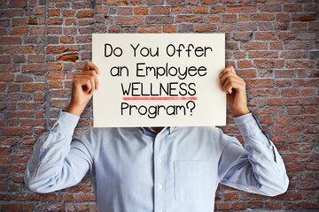 Employee benefits concept with young businessman asking “do you offer an employee wellness...