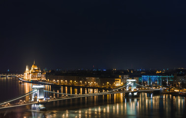 Fototapeta na wymiar Night view of Budapest. Panorama cityscape of famous tourist destination with Danube, parliament and bridges. Travel illuminated landscape in Hungary, Europe.