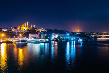 Fototapeta na wymiar Night view of Istanbul. Panorama cityscape of famous tourist destination Golden Horn bay part of Bosphorus strait. Travel illuminated landscape Bosporus, Turkey, Europe and Asia.