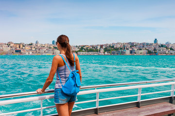 Young tourist woman in Istanbul. Panorama cityscape of famous tourist destination Bosphorus strait channel. Travel landscape Bosporus, Turkey, Europe and Asia.