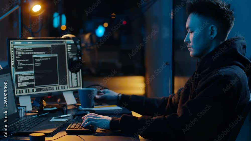 Poster cybercrime, hacking and technology concept - asian male hacker writing code or using computer virus 