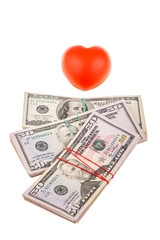 Some American Dollars and red heart isolated on white