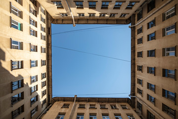 Yard well, against the blue sky and wires. Typical historical buildings of St. Petersburg.