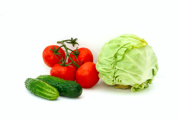On a white background cabbage, cucumbers, tomatoes, linen towel. Concept - vegetable diet, cooking salad.