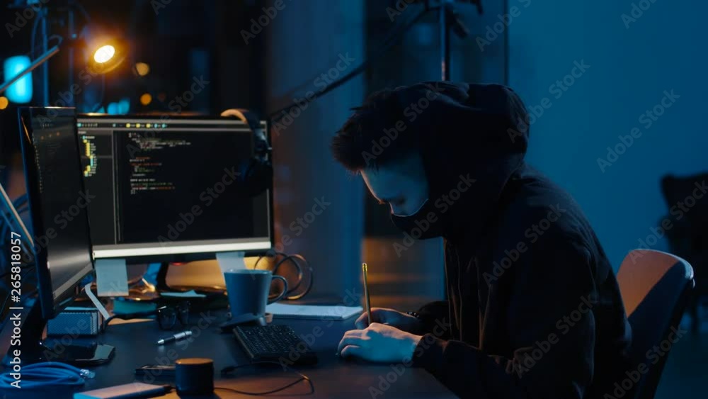 Poster cybercrime, hacking and technology concept - asian male hacker in mask using computer virus program 