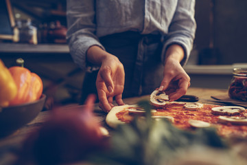 Food ingredients and spices for cooking pizza. Mushrooms, tomatoes, cheese, onion, oil, pepper, salt, basil, olive and delicious italian pizza on dark wooden background. Pizza menu. Homemade cooking.