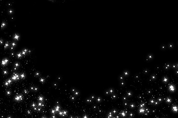 Glittering silver stars on a black background. Festive blank, copyspace.