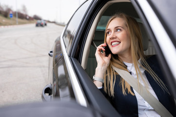 Beautiful businesswoman is driving in the car