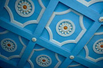 outdoor stucco molding on the ceiling with painted blue backgreound