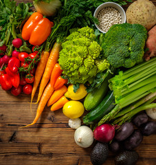 Assortment of fresh vegetables on wooden background