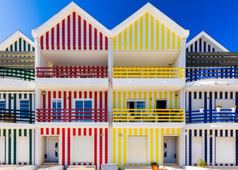 Street with colorful houses in Costa Nova, Aveiro, Portugal. Street with striped houses, Costa Nova, Aveiro, Portugal. Facades of colorful houses in Costa Nova, Aveiro, Portugal.