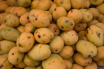 A heap of organic mangoes at a local market