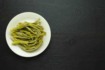 Pickled tumbleweed on a plate. Top view with copy space